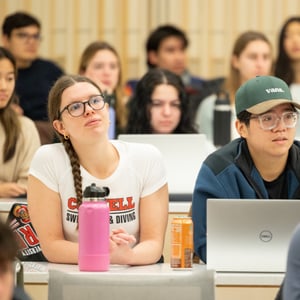 A group of students sitting in a lecture hall with laptops. A group of students sitting in a lecture hall with laptops.